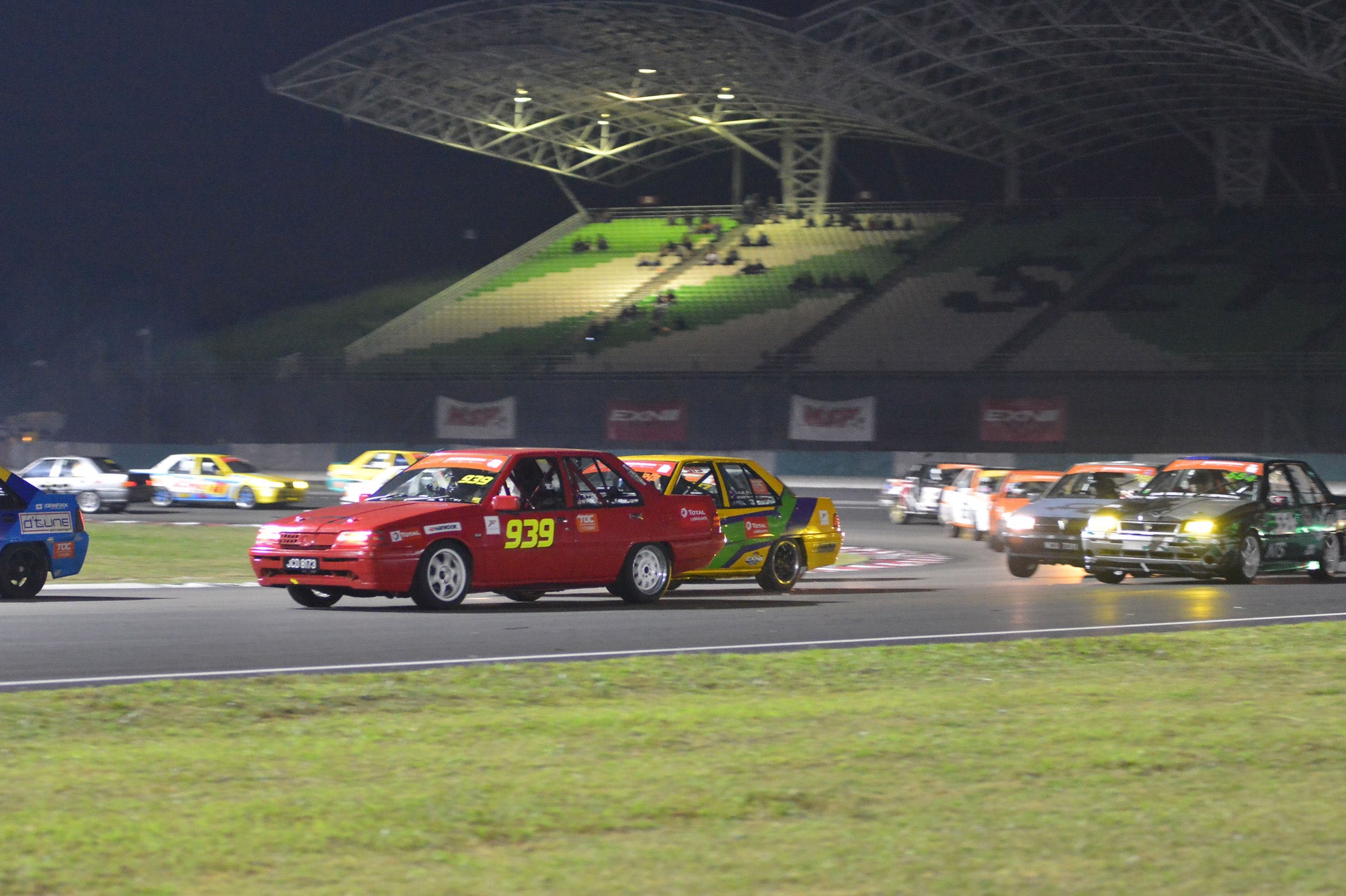 Saga Cup cars negotiating Sepang Circuit's exiting Turn 1